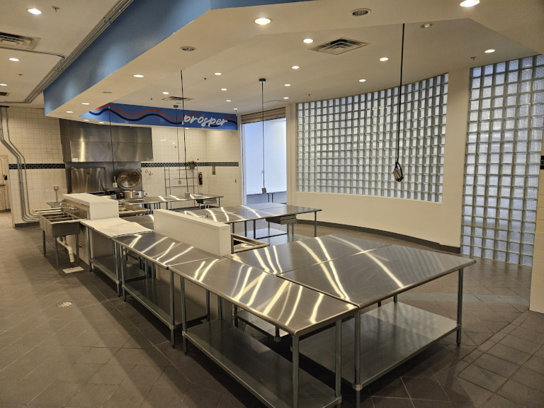 Finished commercial kitchen — stainless equipment and recessed lighting