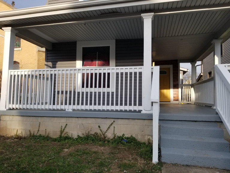 Finished kitchen — white shaker cabinets, quartz, pendant lighting