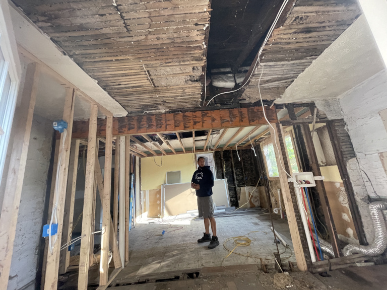 Exposed ceiling joists — termite damage and rot visible
