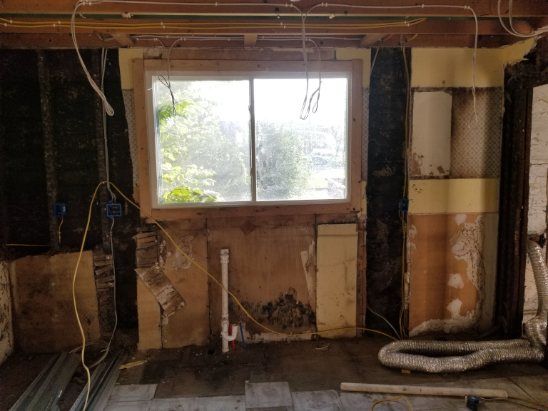 Kitchen cabinets being set — finish phase beginning